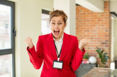 Genç ve güzel bir kadın şokta, gülüyor ve başarıyı kutluyor. VIP geçiş akreditasyon kavramı