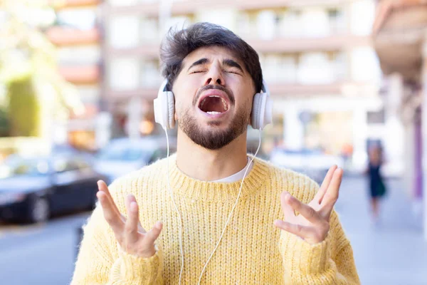 Jovem Bonito Homem Gritando Com Mãos Ouvir Música Com Fones — Fotografia de Stock