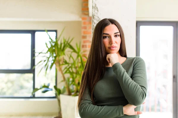 stock image young adult pretty woman looking serious, confused, uncertain and thoughtful, doubting among options or choices