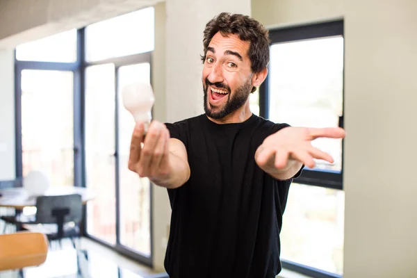 Young Crazy Bearded Smiling Happily Offering Showing Concept Light Bulb — Stock Photo, Image