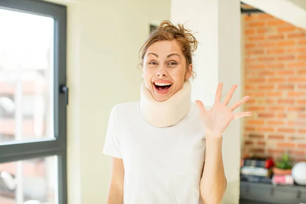 stock image young pretty woman feeling happy and astonished at something unbelievable. accident collar concept