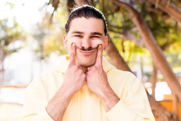 Jovem Homem Legal Sorrindo Confiantemente Apontando Para Próprio Sorriso Falso — Fotografia de Stock