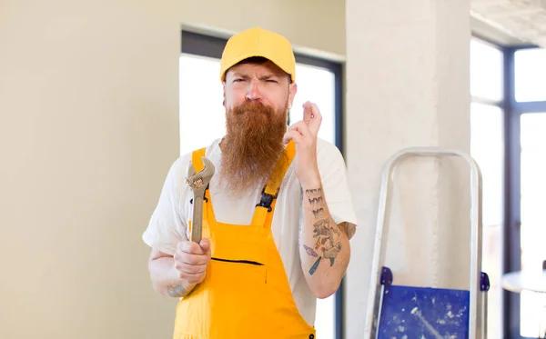 Red Hair Man Crossing Fingers Hoping Good Luck Repairing Home — Stock Photo, Image