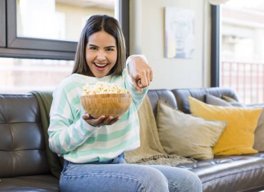 pretty latin woman film and popcorn