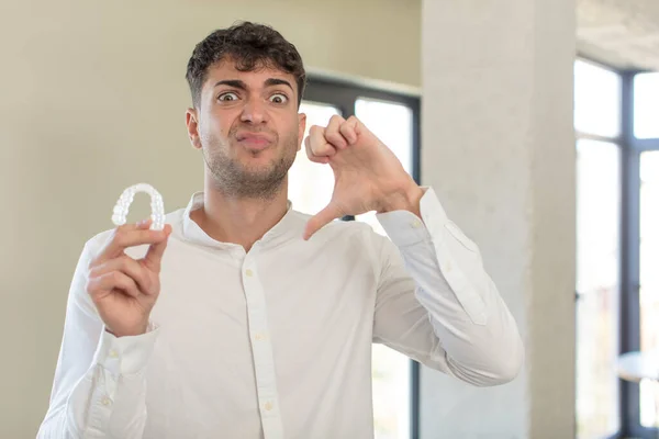 Young Handsome Man Feeling Cross Showing Thumbs Dental Retainer Concept — Stock Photo, Image