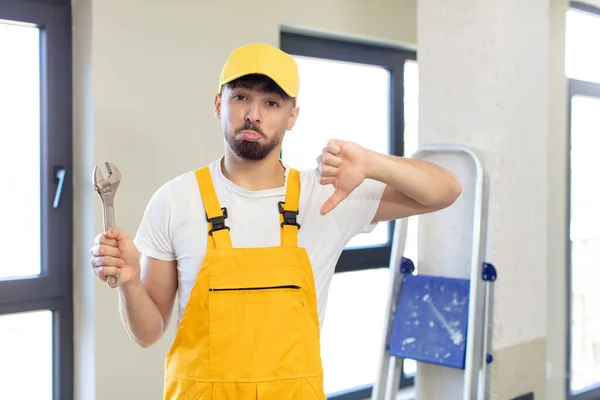 Young Handsome Man Feeling Cross Showing Thumbs Handyman Concept — Stock Photo, Image