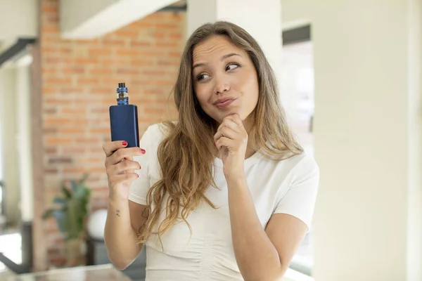 stock image pretty woman smiling with a happy, confident expression with hand on chin. vaper concept