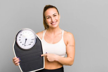 young pretty woman with a scale. diet and fitness concept