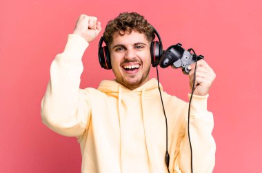 young adult caucasian man with headset and a controller. gamer concept