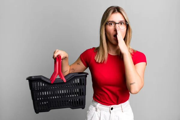 Young Pretty Woman Covering Mouth Hands Shocked Empty Shopping Basket — Foto Stock