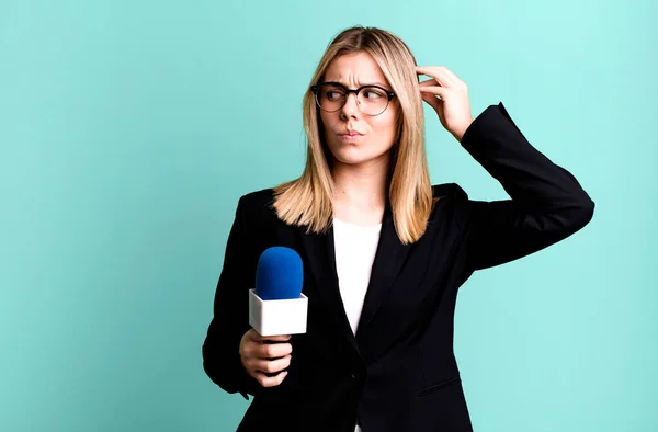 stock image young pretty woman smiling happily and daydreaming or doubting. presenter or journalist concept