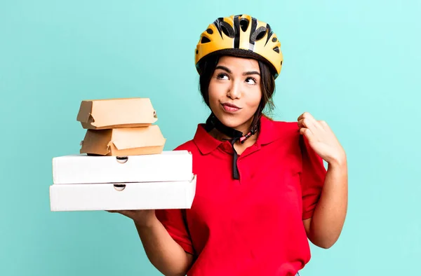 stock image hispanic pretty woman looking arrogant, successful, positive and proud.  delivery woman and take away concept