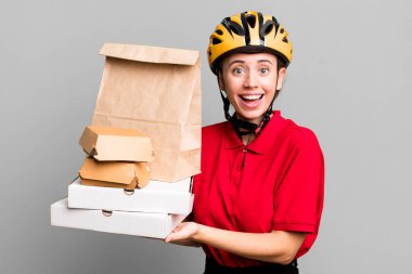 pretty blonde deliverywoman with a paper bag