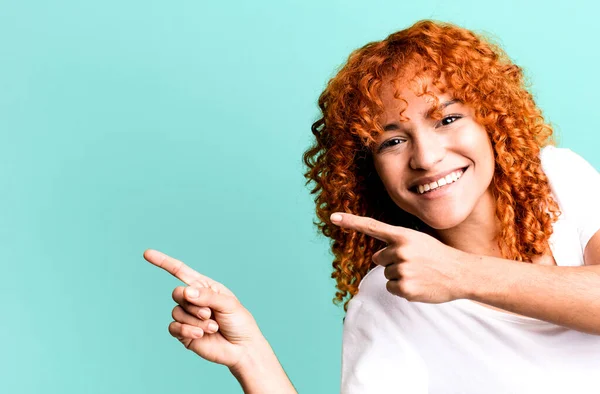 stock image red hair pretty woman with a copy space to the side. presenting something