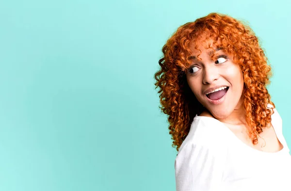 stock image red hair pretty woman with a copy space to the side. presenting something