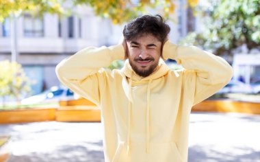 Genç yakışıklı adam hayal kırıklığına uğramış ve sıkılmış hissediyor, başarısızlıktan bıkmış ve bıkmış, sıkıcı işlerden bıkmış