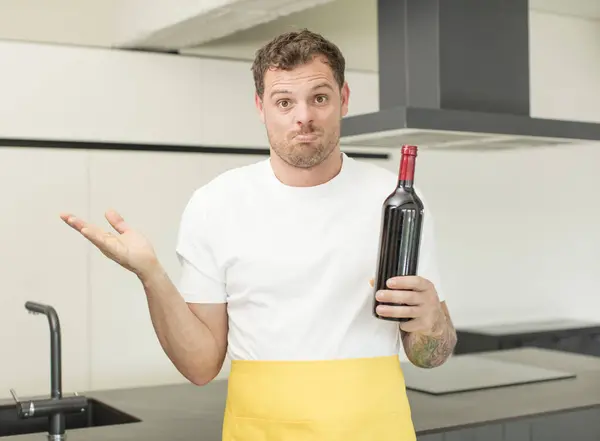 stock image shrugging, feeling confused and uncertain. bottle of wine concept