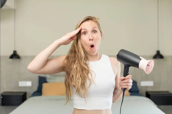 stock image looking happy, astonished and surprised. hair dryer concept