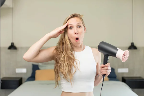 Stock image looking happy, astonished and surprised. hair dryer concept