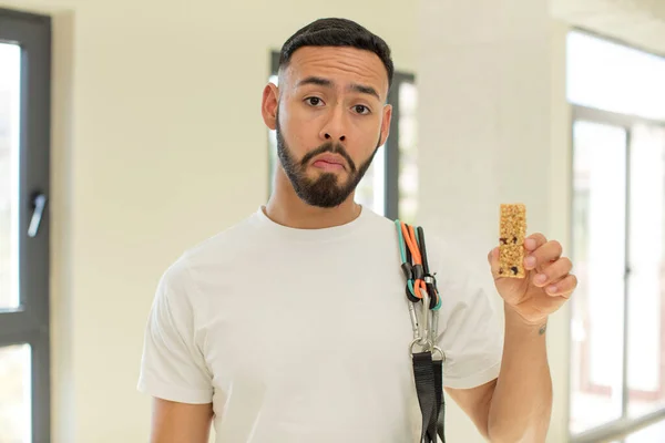 arab handsome man arab man feeling sad and whiney with an unhappy look and crying.  fitness and cereal bar concept