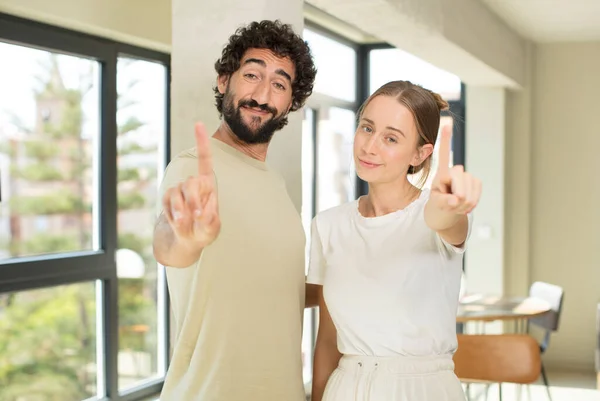 Young Adult Couple Smiling Proudly Confidently Making Number One Pose — Stock Photo, Image