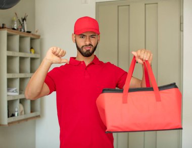 Genç yetişkin bir adam kendini kötü hissediyor, baş parmağını kaldırıyor. Pizza teslimatçısı konsepti