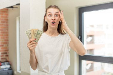 Mutlu, şaşkın ve şaşırmış görünüyor. Dolar banknotları konsepti