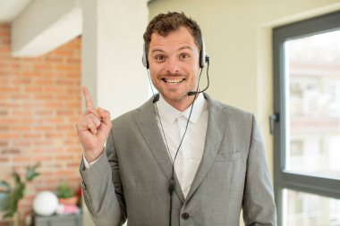 smiling cheerfully, feeling happy and pointing to the side. telemarketer concept