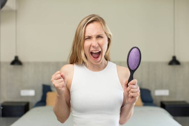 looking angry, annoyed and frustrated. hair comb concept