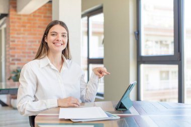 young pretty woman smiling cheerfully, feeling happy and showing a concept. telecommuting concept