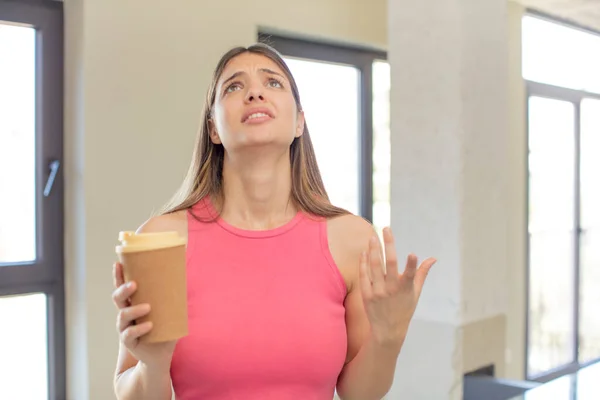 stock image young pretty woman screaming with hands up in the air. take away coffee concept