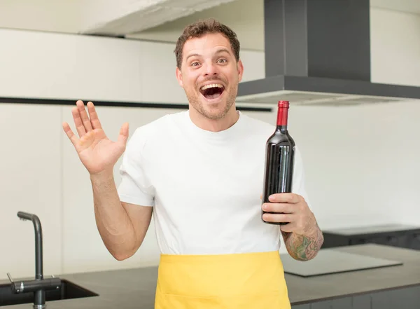 stock image feeling happy and astonished at something unbelievable. bottle of wine concept