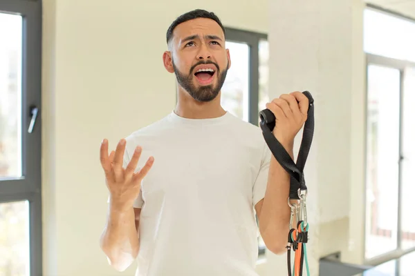 arab handsome man arab man screaming with hands up in the air. fitness concept