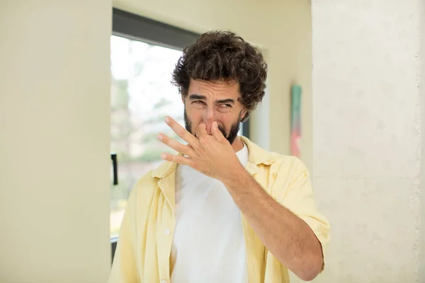 Young Crazy Bearded Man Feeling Disgusted Holding Nose Avoid Smelling — Stock Photo, Image