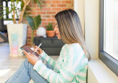 pretty latin woman using a pad at home