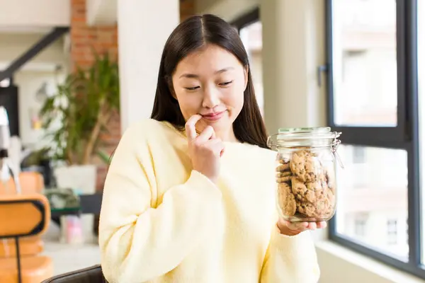 Asian Pretty Woman Eating Cookies Cool Living Room — Stockfoto