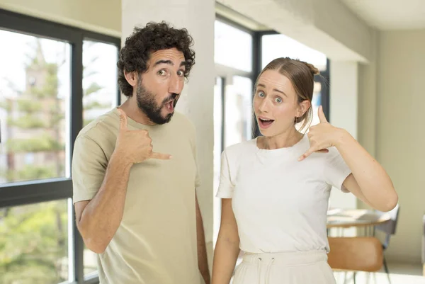 Young Adult Couple Crazy Happily Cheerfully Waving Hand Welcoming Greeting — Stock Photo, Image