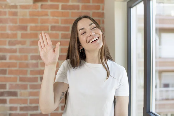 Young Adult Pretty Woman Smiling Happily Cheerfully Waving Hand Welcoming — Stockfoto