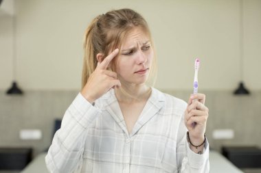 Genç, güzel bir kadın şaşırmış görünüyor, yeni bir düşünce, fikir ya da konsept fark ediyor. diş yıkama kavramı