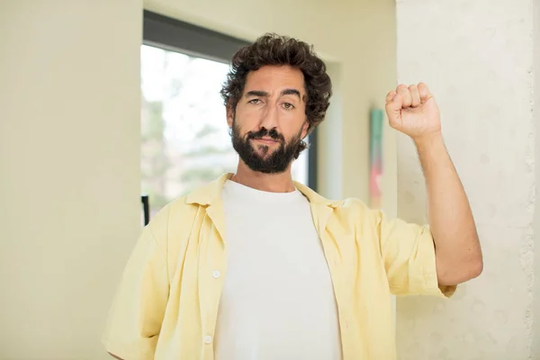 Young Crazy Bearded Man Feeling Serious Strong Rebellious Raising Fist — Stock Photo, Image