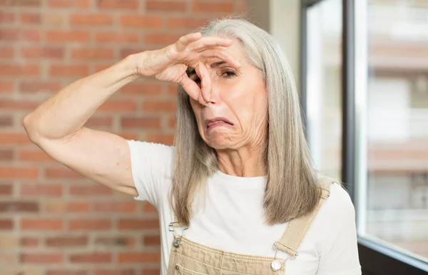 Senior Pretty Woman Feeling Disgusted Holding Nose Avoid Smelling Foul — Stock Photo, Image