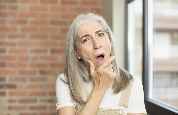 Senior Pretty Woman Mouth Eyes Wide Open Hand Chin Feeling — Stock Photo, Image