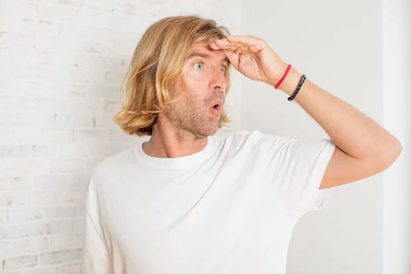 Young Blond Adult Man Looking Bewildered Astonished Hand Forehead Looking — Stock Photo, Image