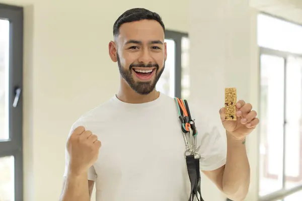 arab handsome man arab man feeling shocked,laughing and celebrating success.  fitness and cereal bar concept