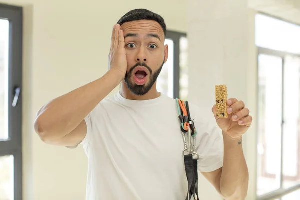 arab handsome man arab man feeling extremely shocked and surprised.  fitness and cereal bar concept