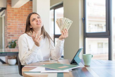 young pretty woman screaming with hands up in the air. telecommuting concept