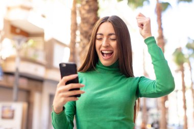 Akıllı telefon kullanan bir model.