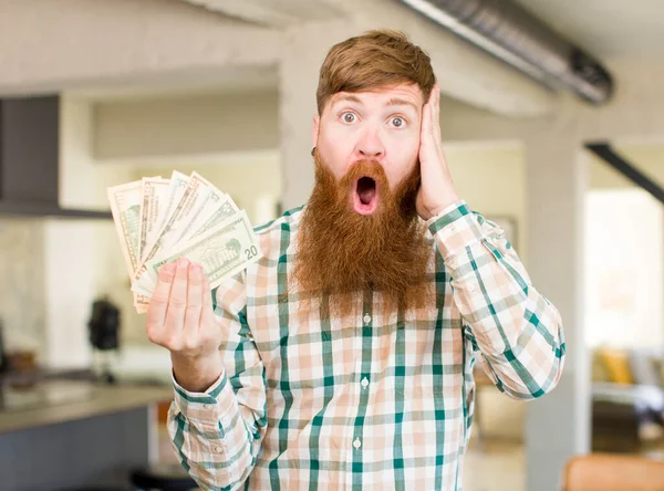 Red Hair Man Feeling Extremely Shocked Surprised Dollar Banknotes — Stock Photo, Image