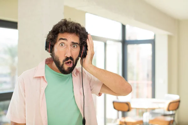 young crazy man listening music with headphones