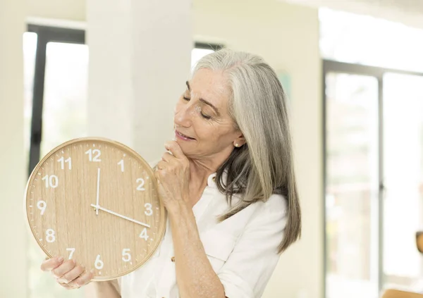 senior woman with a clock